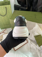 Gucci unisex sneakers, black and white, heel view with Gucci logo on back