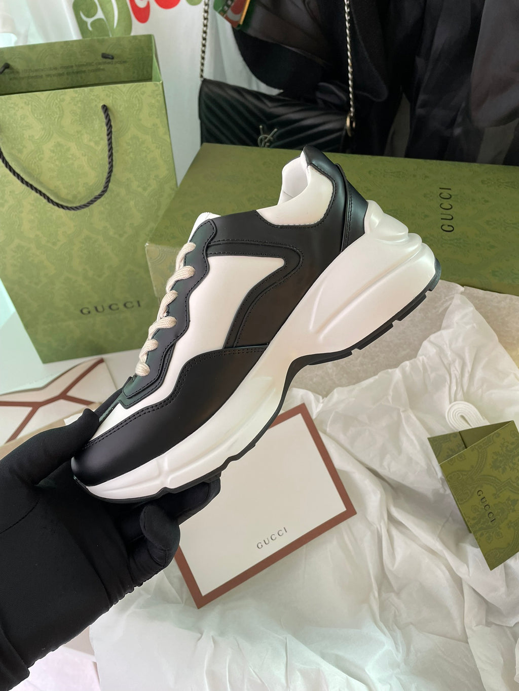 Gucci unisex sneakers, black and white, side view with sculpted white midsole