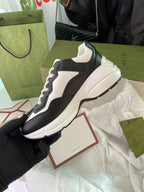 Gucci unisex sneakers, black and white, side view with sculpted white midsole