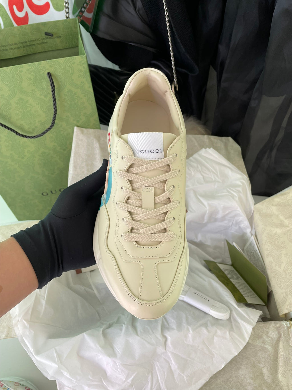 Beige lace-up Gucci sneakers with stitched panels, front view