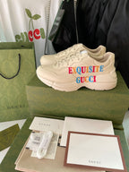 Cream Gucci sneakers with red and blue “EXQUISITE GUCCI” lettering on side
