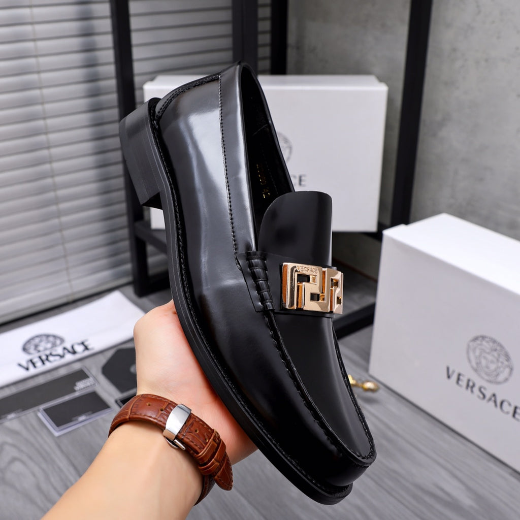 Luxury shoes Versace black leather loafer with gold Greca buckle, shown near heel