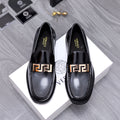 Luxury shoes Versace black leather loafers with gold Greca buckle detail