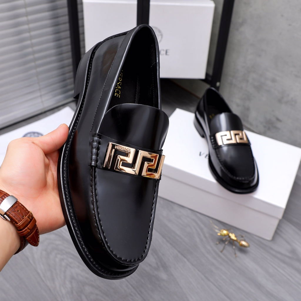 Luxury shoes Versace black leather loafer with gold Greca buckle, side view