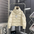 Moncler long puffer jacket in light cream, hooded, full-zip front with button placket