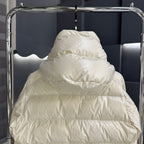 Moncler long puffer jacket close-up on hood, light cream quilted padding