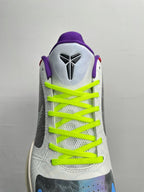 Basketball shoes with white heel and tongue, neon green laces, and purple collar