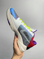 Basketball shoes three-quarter view with neon green laces, blue toe, and purple heel