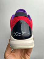 Basketball shoes rear view with black heel counter, red upper, and light beige outsole