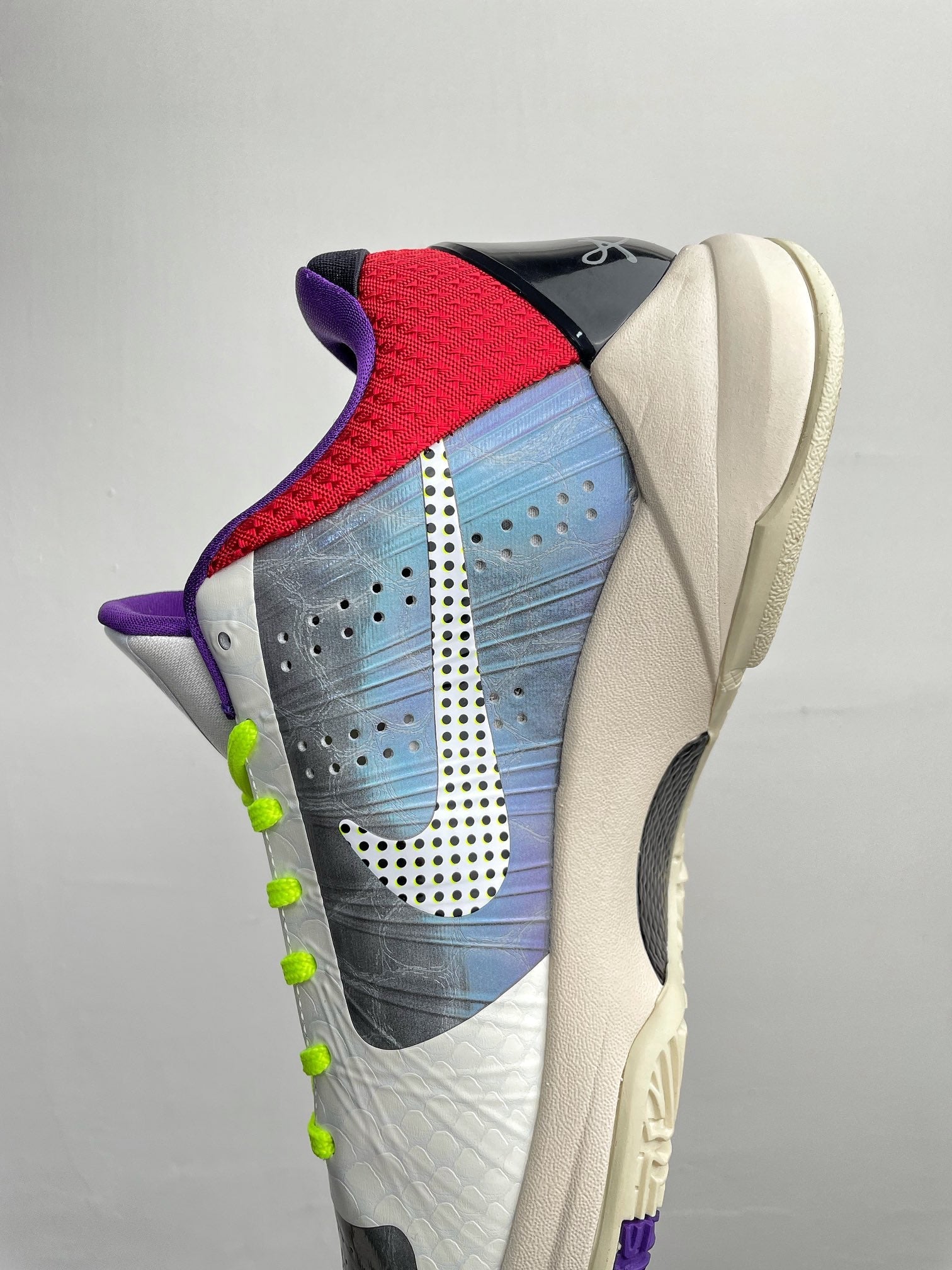Basketball shoes with red heel overlay, blue textured panel, and neon green laces