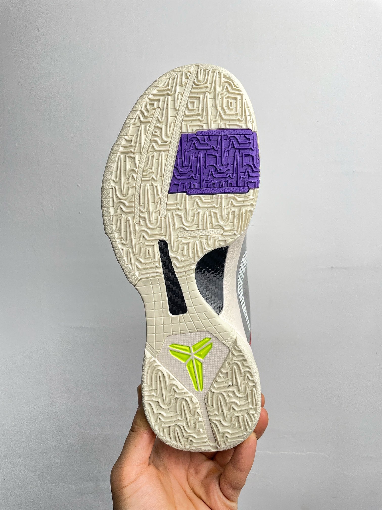 Basketball shoes outsole view with beige traction tread and blue heel detail