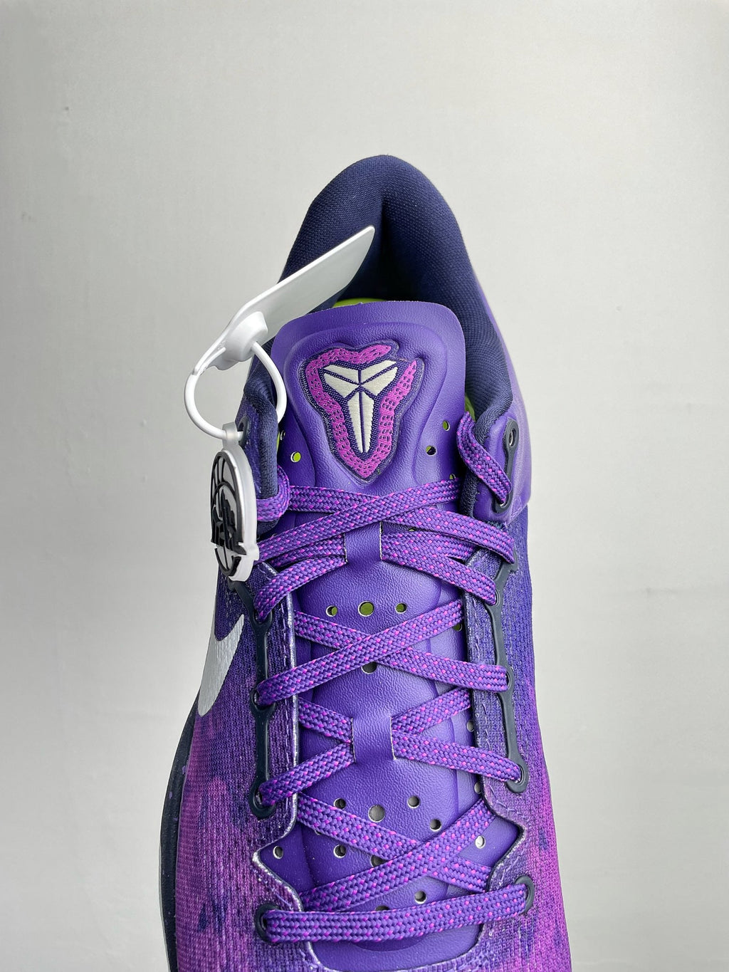 Purple lace-up basketball shoe with front laces, padded tongue, and white swoosh