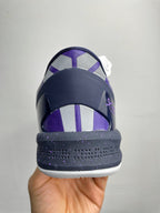 Purple and dark navy basketball shoe heel with white midsole and lace eyelets