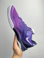 Purple basketball shoe with white midsole, side Nike swoosh, and lace-up design