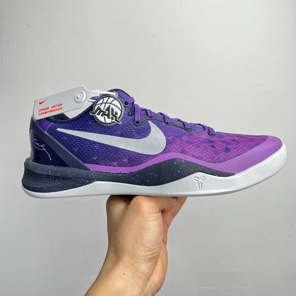 Purple and dark navy lace-up basketball shoe with white midsole and Nike swoosh