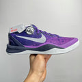 Purple and dark navy lace-up basketball shoe with white midsole and Nike swoosh