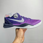 Purple and dark navy lace-up basketball shoe with white midsole and Nike swoosh