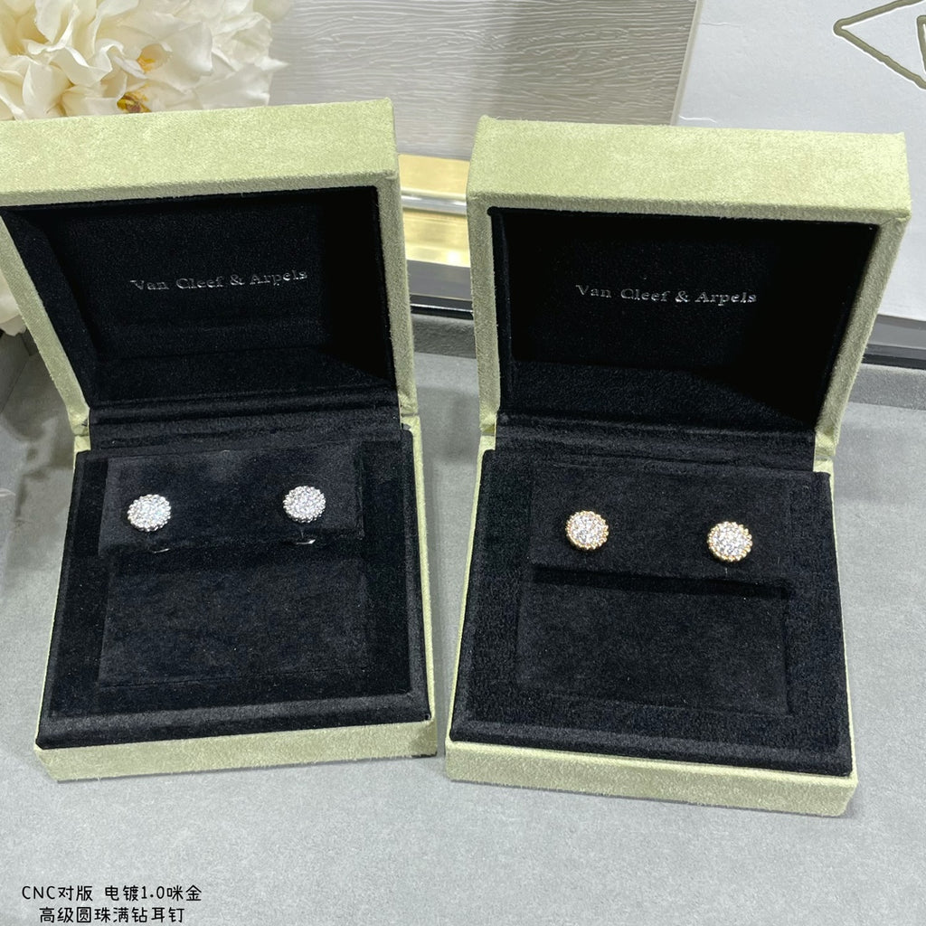 Round stud earrings in two open boxes: silver-toned on the left, gold-toned on the right