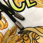 Versace patterned shorts black drawstring with gold logo tips on white fabric