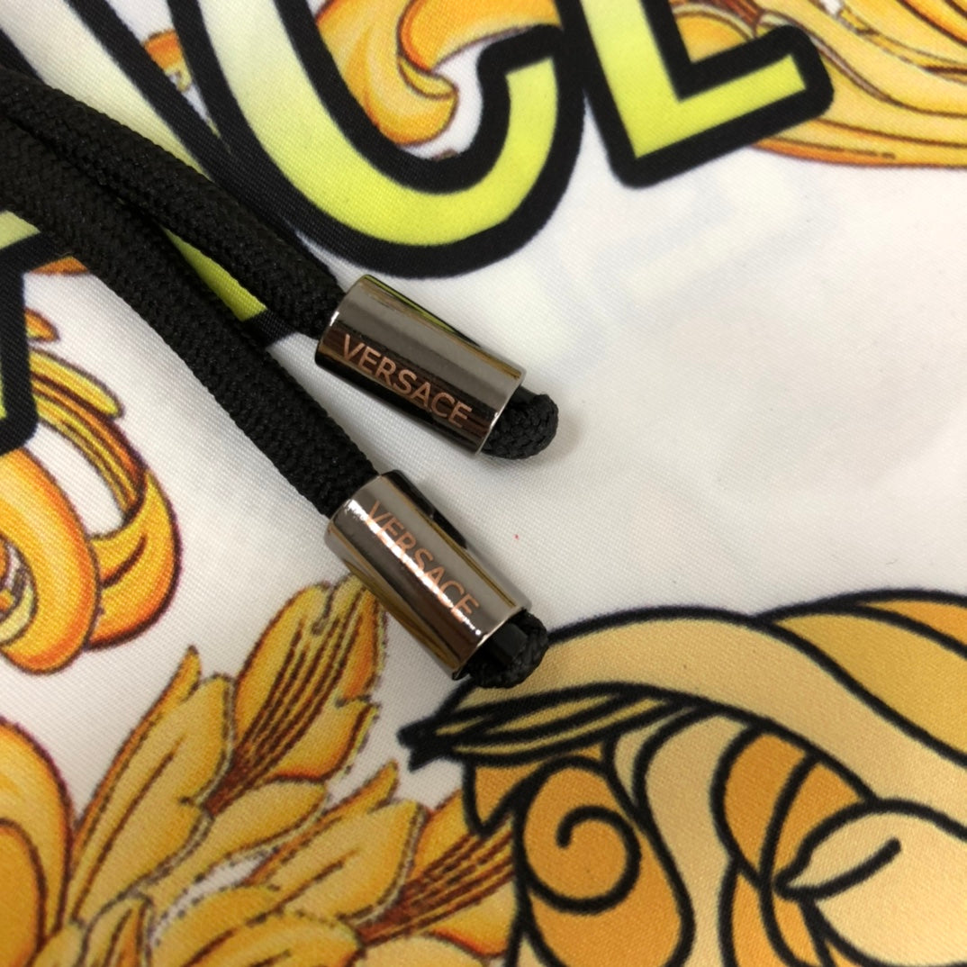 Versace patterned shorts black drawstring with gold logo tips on white fabric