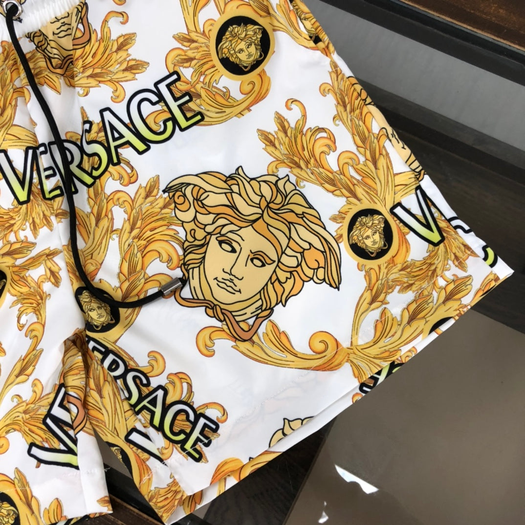 Versace patterned shorts side view in white with gold baroque faces and VERSACE logo