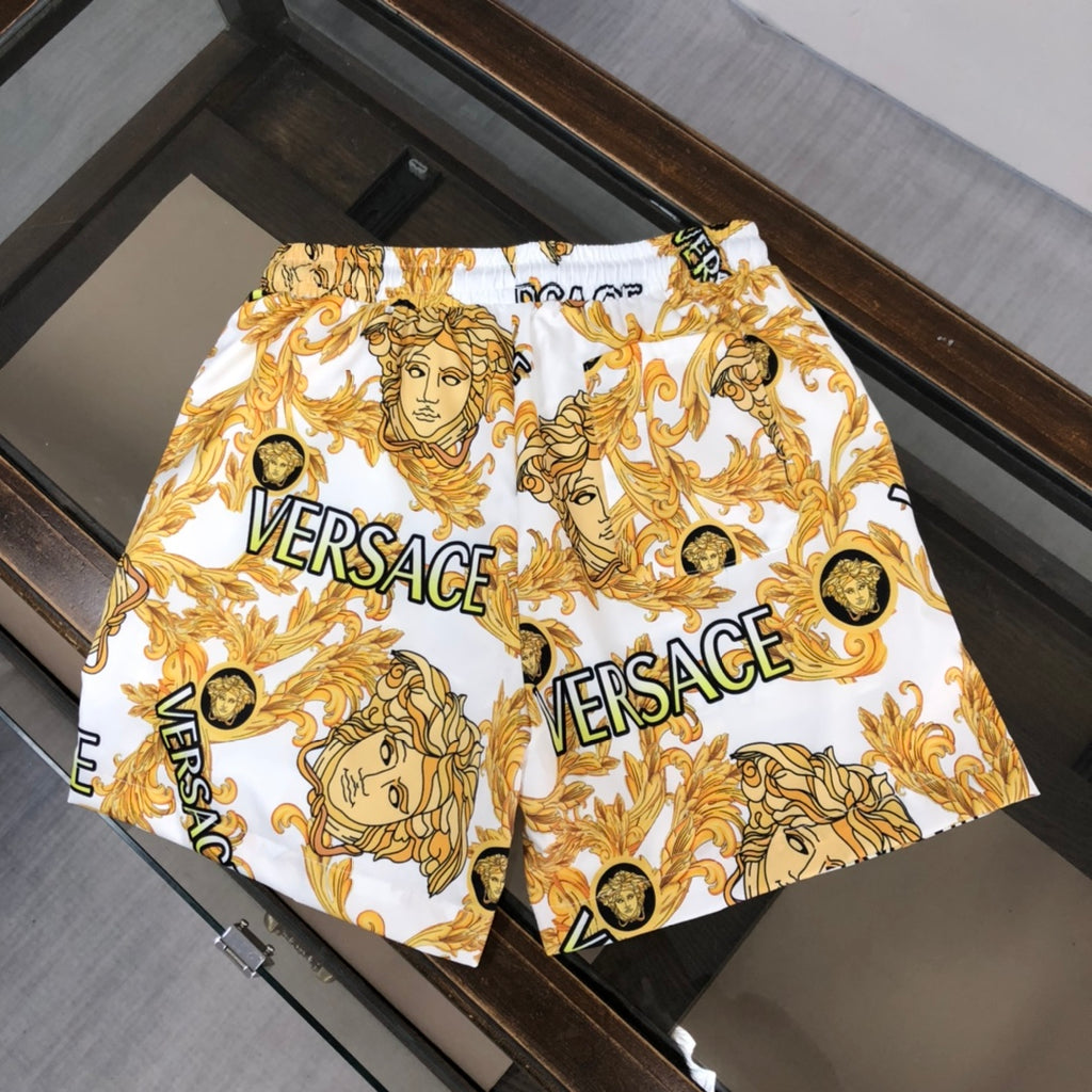 Versace patterned shorts front view in white with gold baroque faces and VERSACE logos