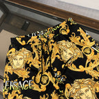 Versace baroque face printed shorts, black with gold motifs, elastic waistband and drawstring