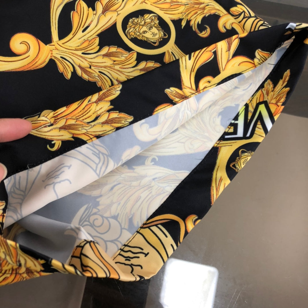 Versace shorts interior lining in light gray with gold-bar pattern, black exterior print