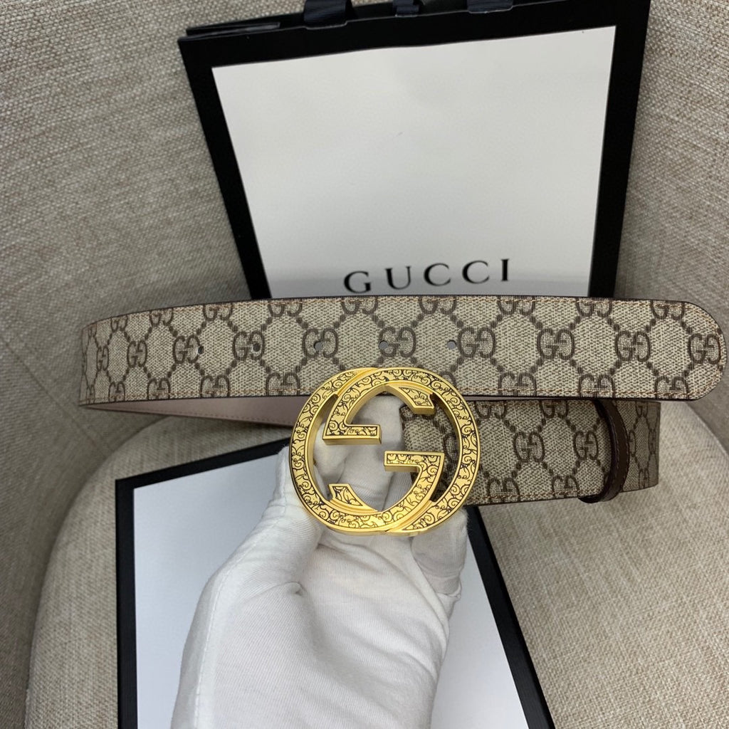Gucci belt with GG monogram canvas strap and gold-tone G buckle, brown backing.