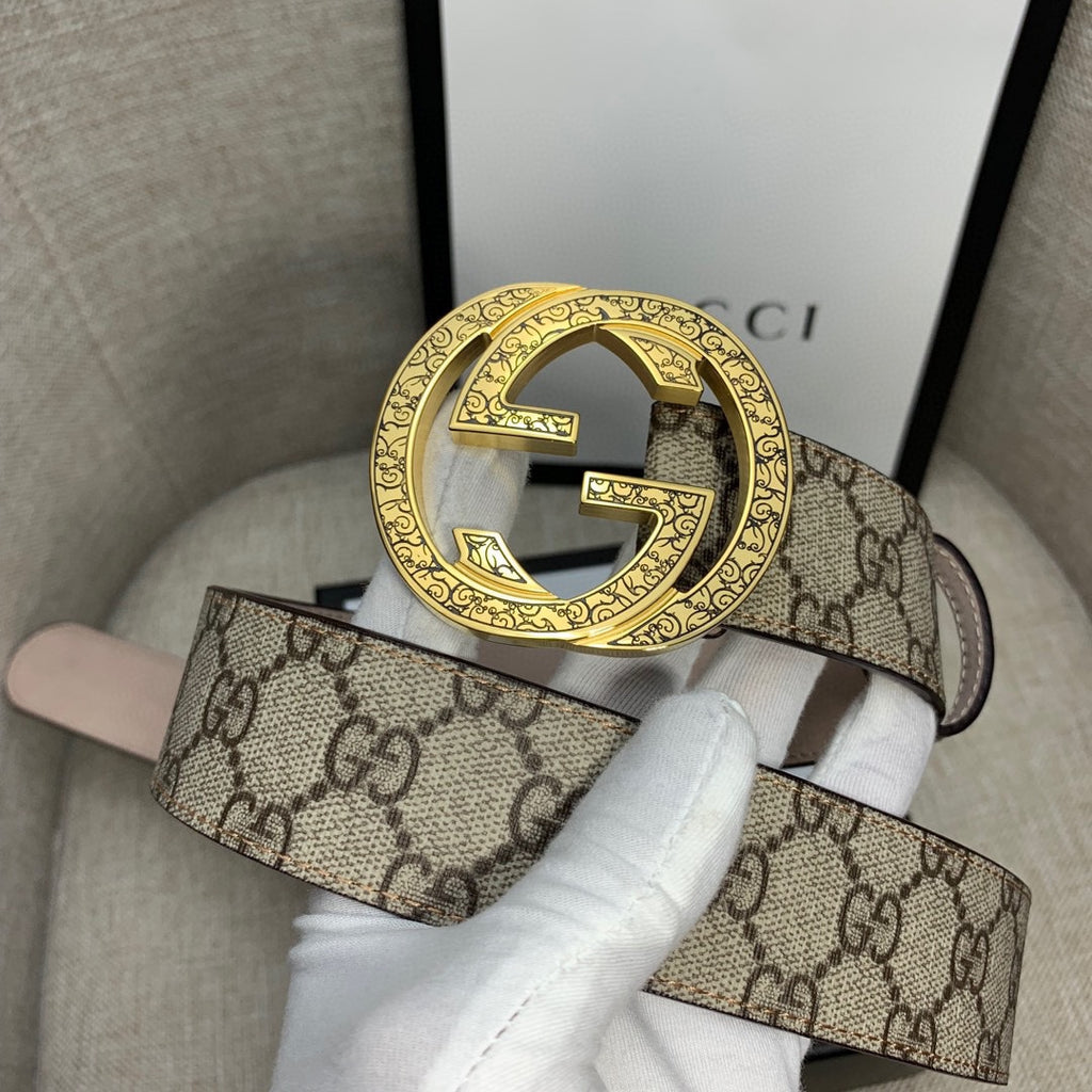 Gucci belt with GG monogram canvas strap and gold-tone G buckle detail.