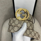 Gucci belt with GG monogram canvas and large gold-tone G buckle, brown leather edging.