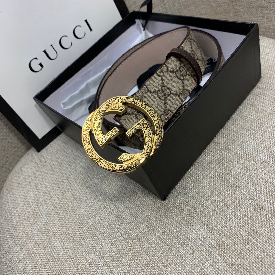 Gucci belt with GG monogram canvas and gold-tone G buckle, brown leather trim in view.