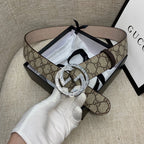 Gucci GG canvas belt with circular silver G buckle and dark brown leather strap