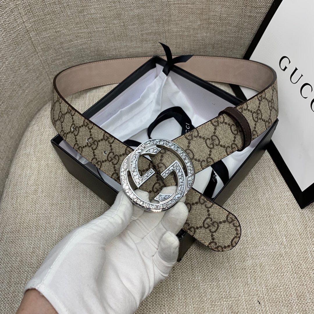 Gucci GG canvas belt with circular silver G buckle and dark brown leather strap
