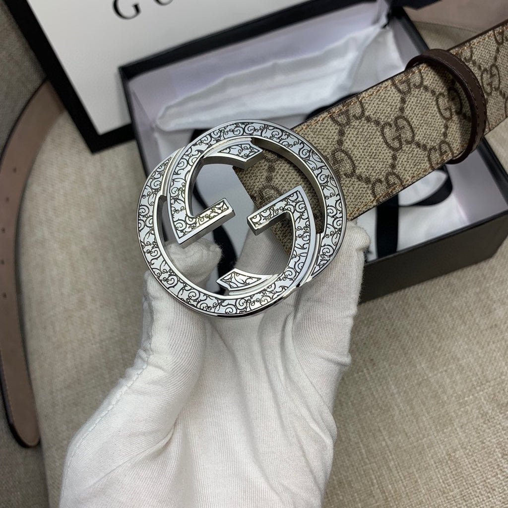 Gucci GG canvas belt with close-up silver G buckle and dark brown leather strap