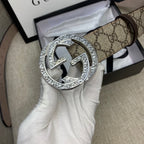 Gucci GG canvas belt with close-up silver G buckle and dark brown leather strap
