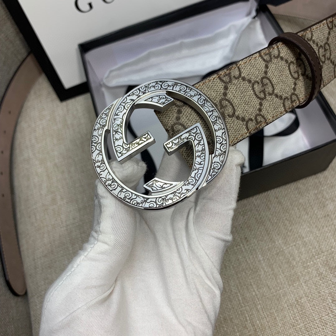 Gucci GG canvas belt with close-up silver G buckle and dark brown leather strap