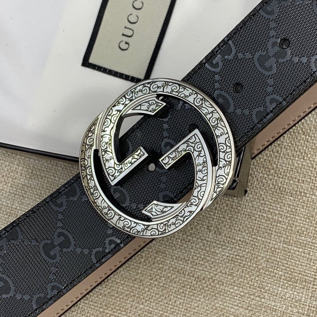 Belt buckle close-up: silver double-G medallion on dark GG canvas strap.