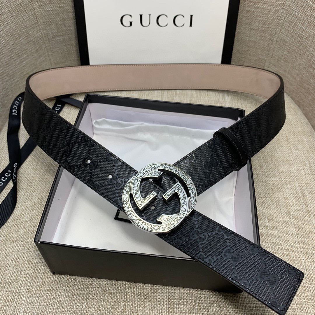 Belt with dark GG canvas strap, silver double-G buckle, and tan inner belt.