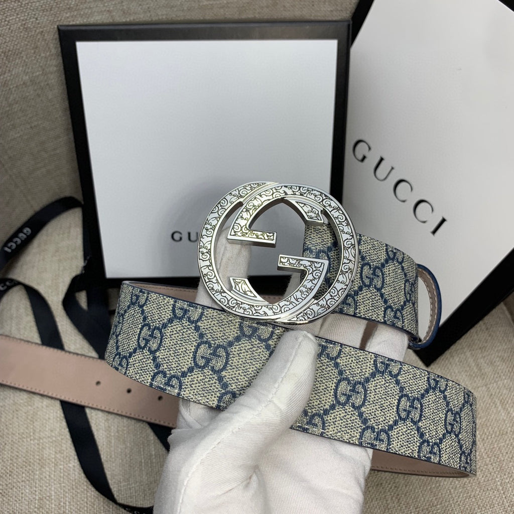 Gucci belt with blue GG canvas strap and silver-tone G buckle, close-up