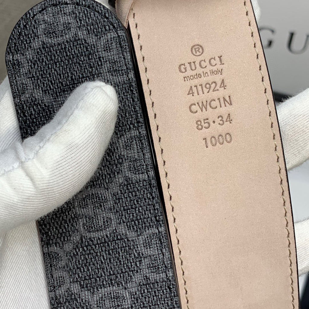 Gucci belt size label on inner strap, beige leather tab with printed codes.