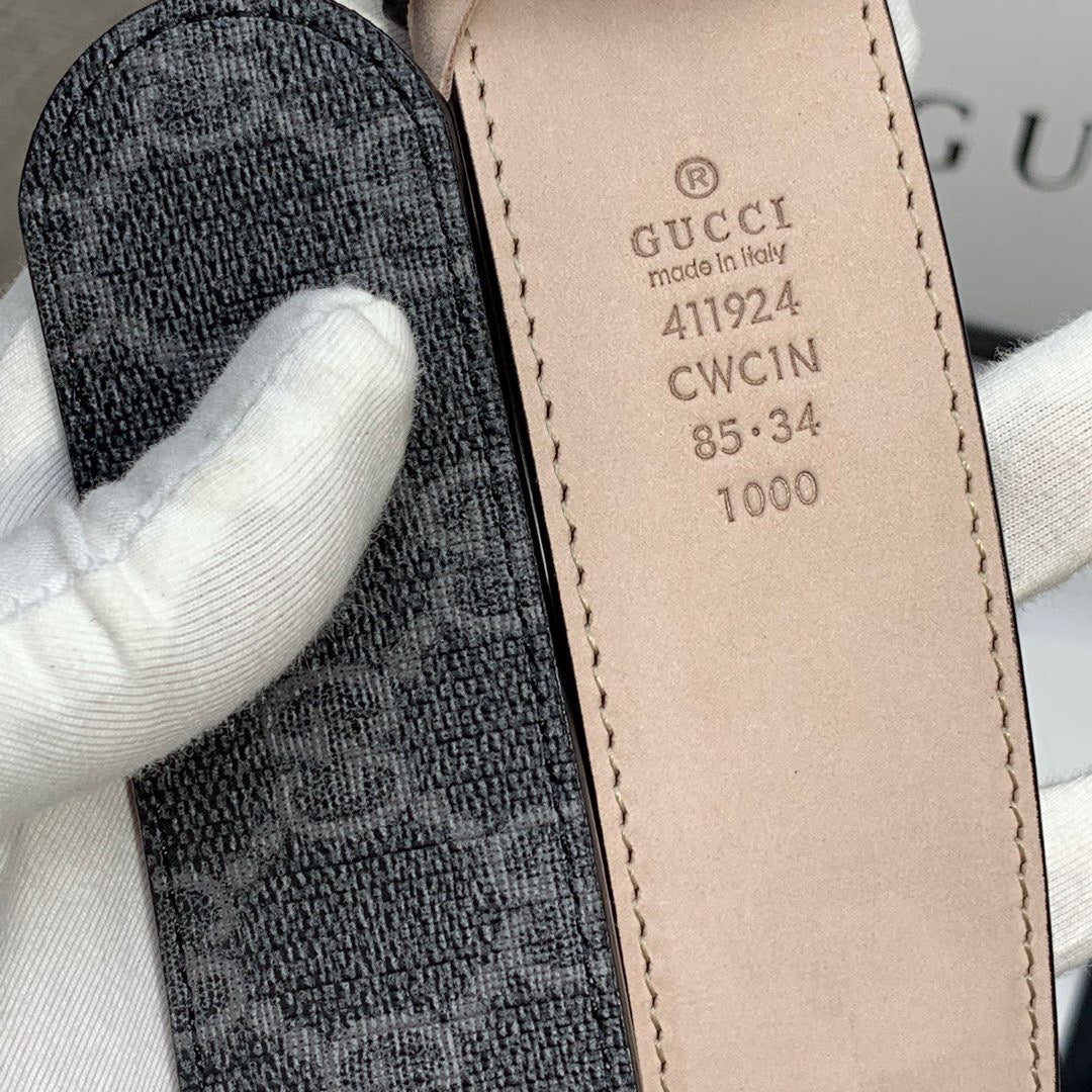 Gucci belt size label on inner strap, beige leather tab with printed codes.