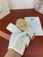 White leather belt with gold rhinestone oval buckle and perforated strap
