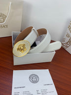 White leather belt with oval rhinestone lion buckle in a gift box