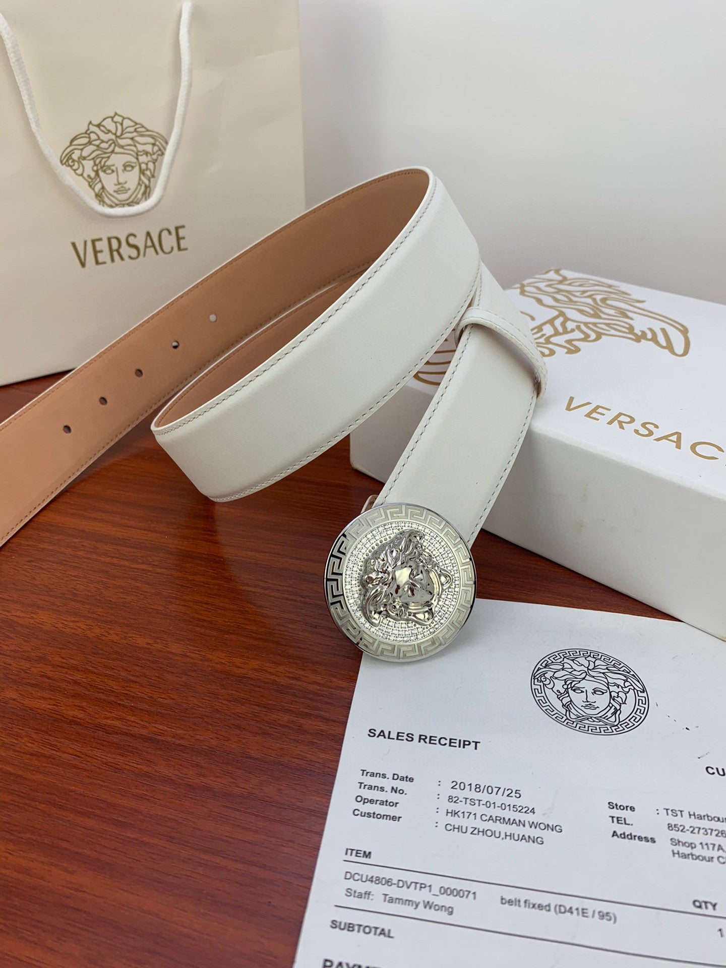 White leather belt with silver Medusa medallion buckle and smooth tan underside