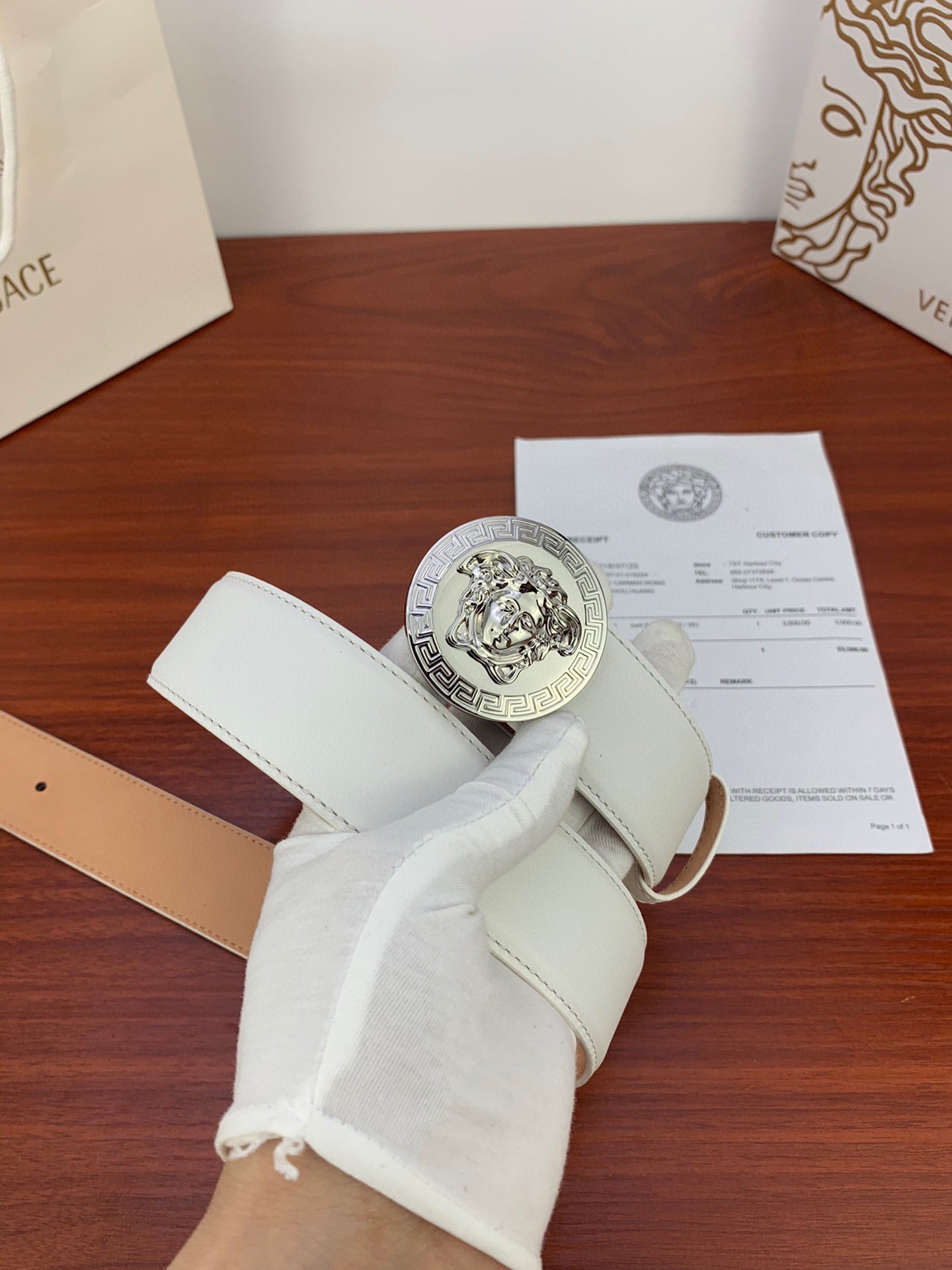 White leather belt with silver Medusa coin buckle and folded strap end