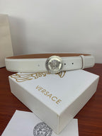 White leather belt with silver Medusa coin buckle, stitched edge, and prong holes