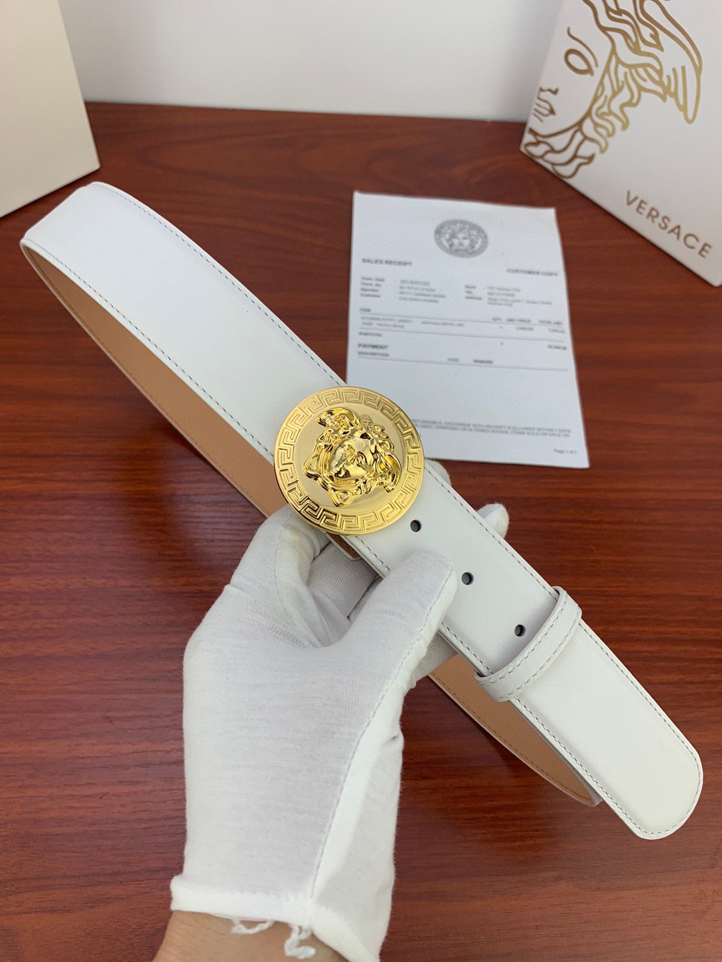 White leather belt with gold Medusa coin buckle and single prong holes