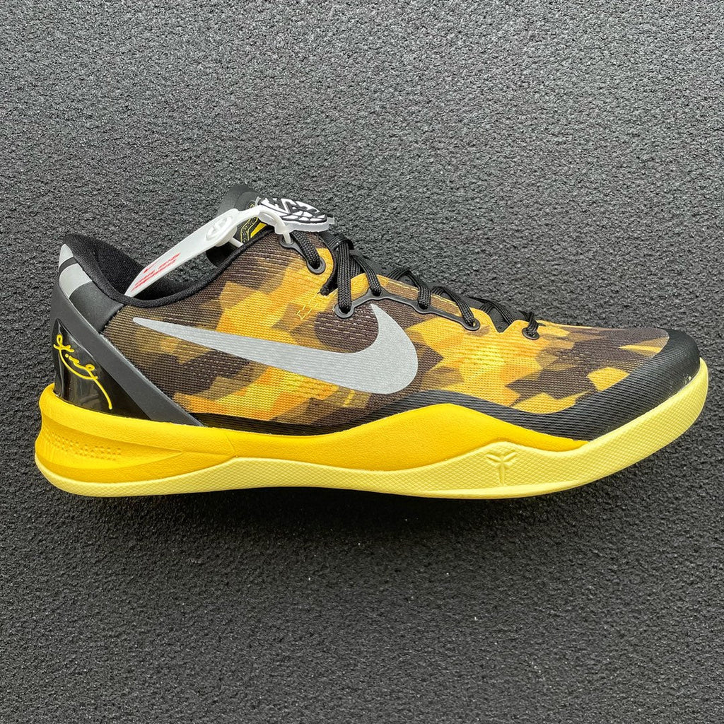 Black, yellow camo basketball shoe with white swoosh and yellow sole