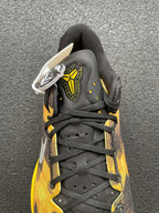 Lace-up black and yellow camo basketball shoe with white logo tag